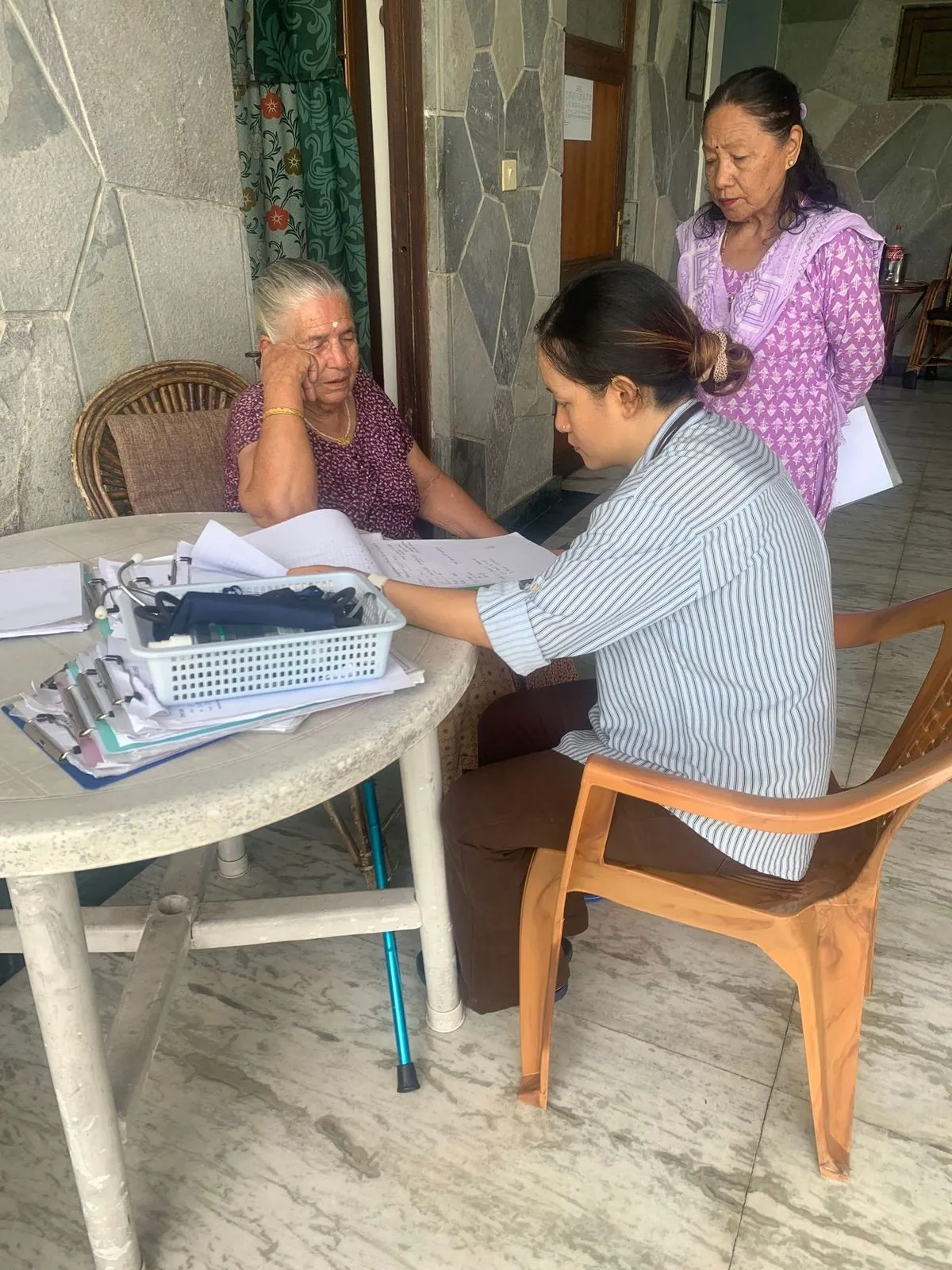 A nurse checking a resident's blood pressure