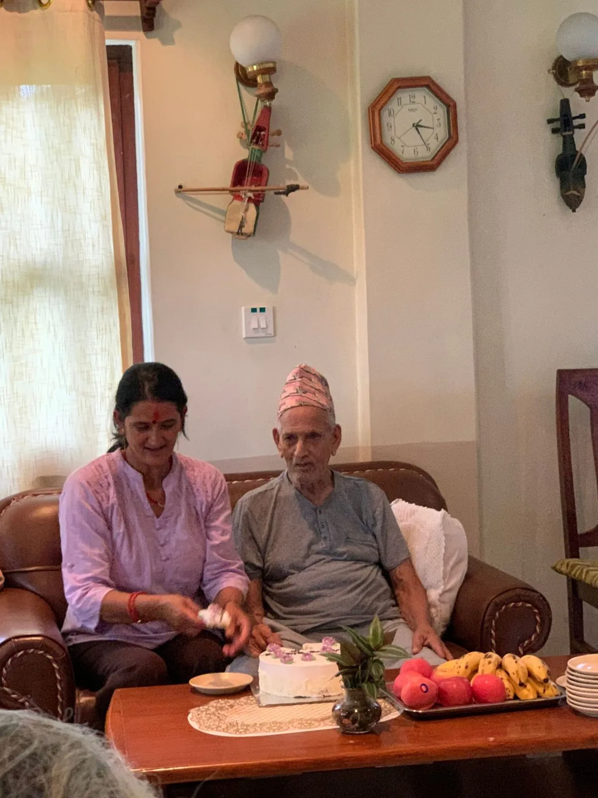 A resident with family and fruit during visiting hours