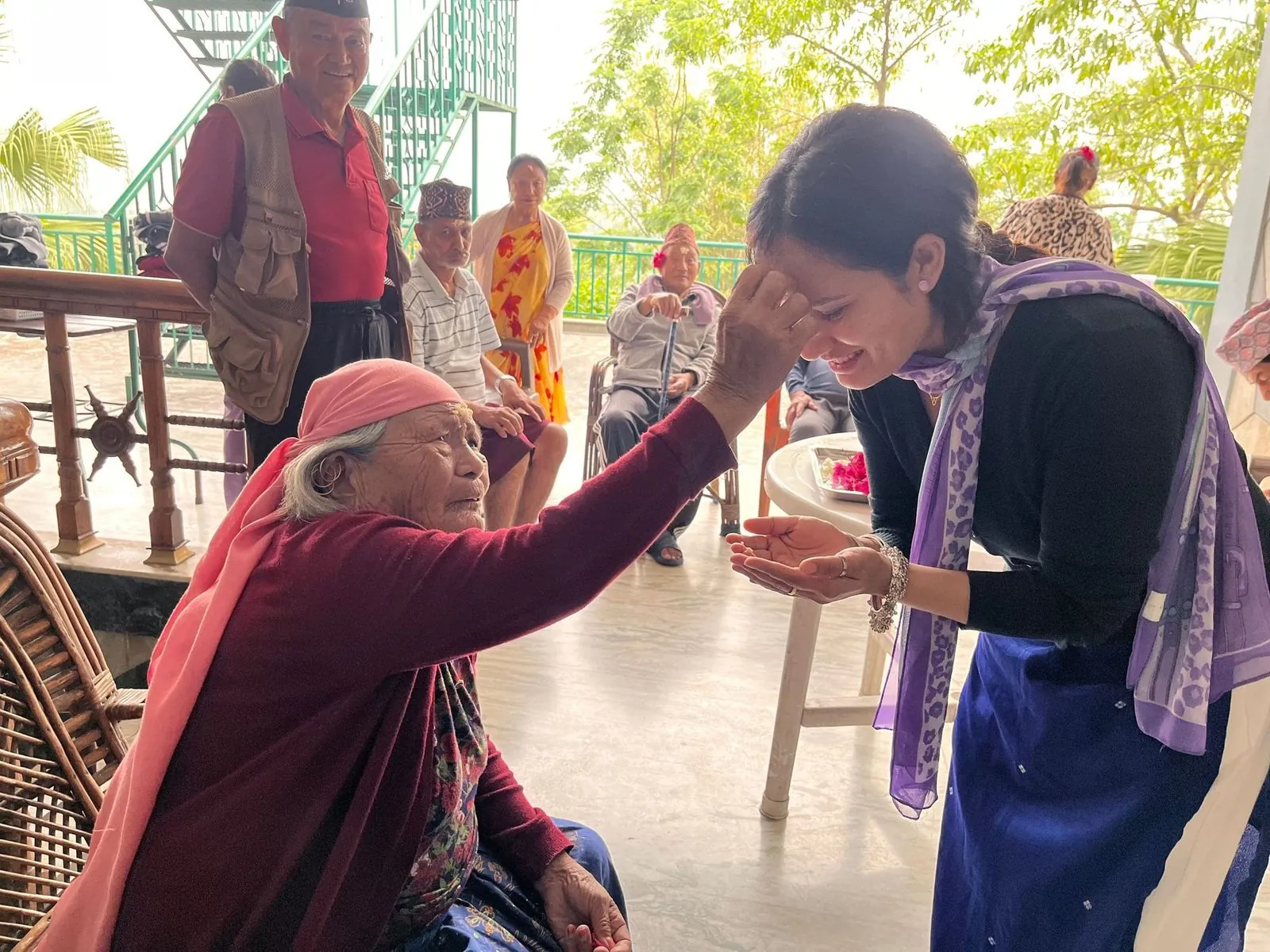 A resident receiving tika during a festival