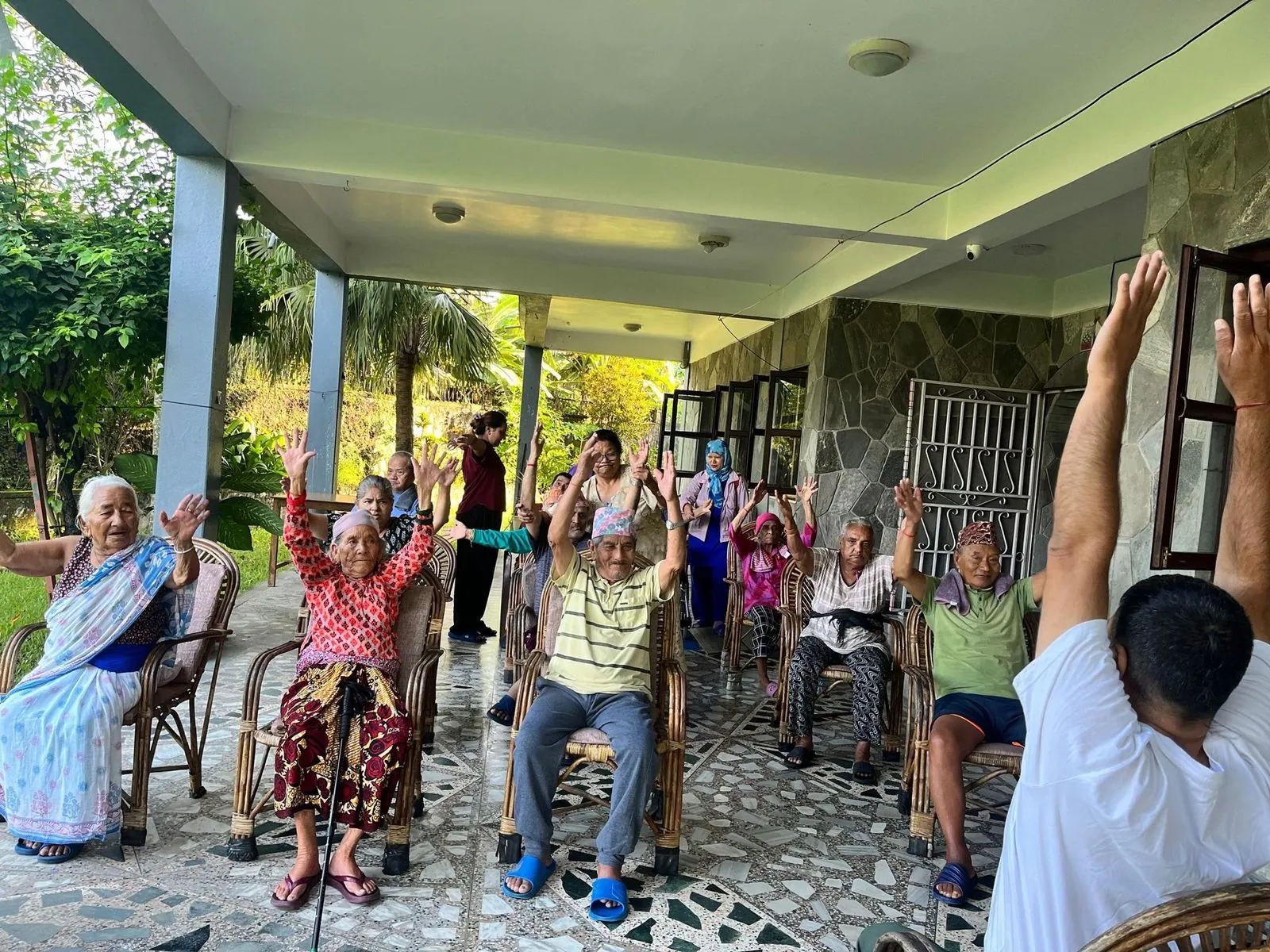 Residents doing a gentle exercise session on the verandah